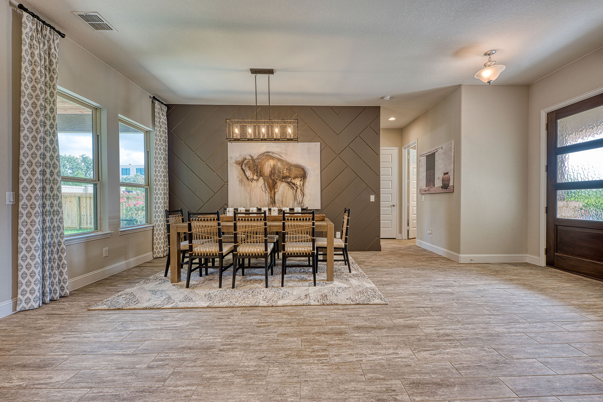 Pond Hill - 2 dining Spacious modern dining room with artwork and windows.